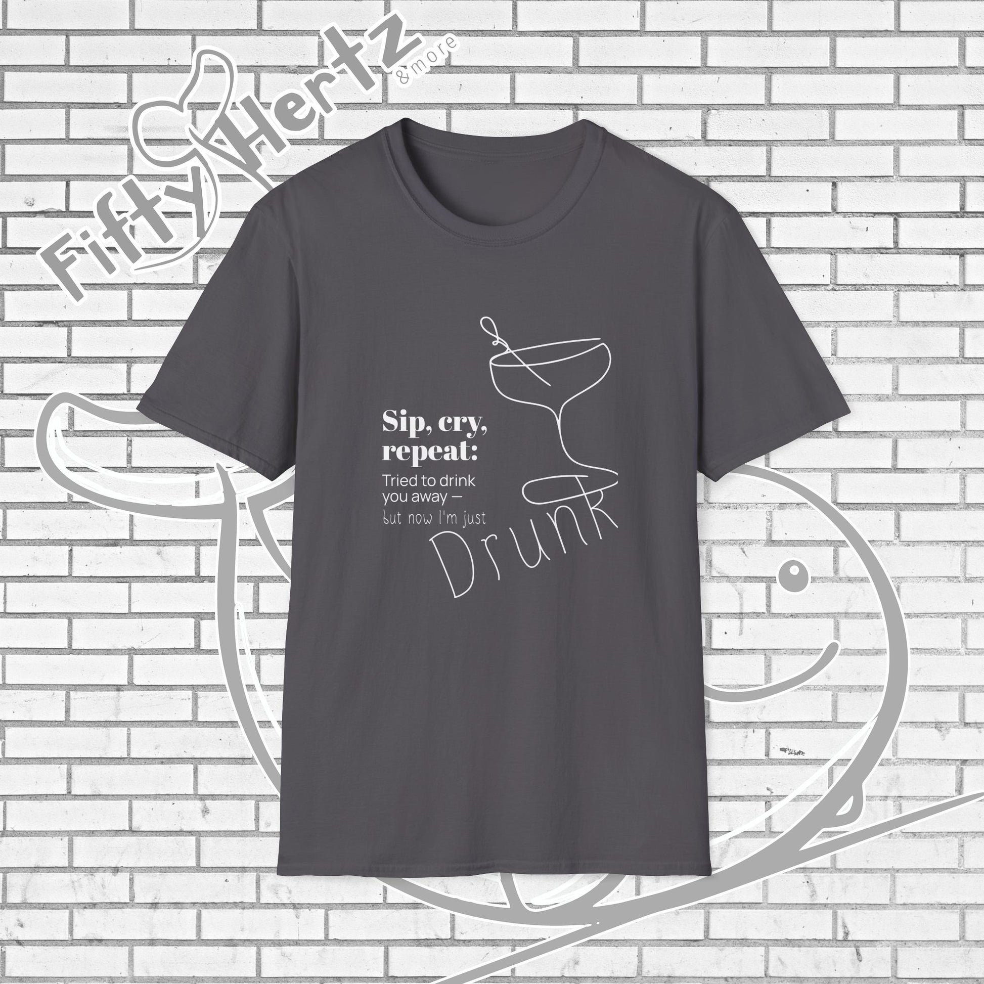 Gray t-shirt with humorous text and graphic on a brick wall background